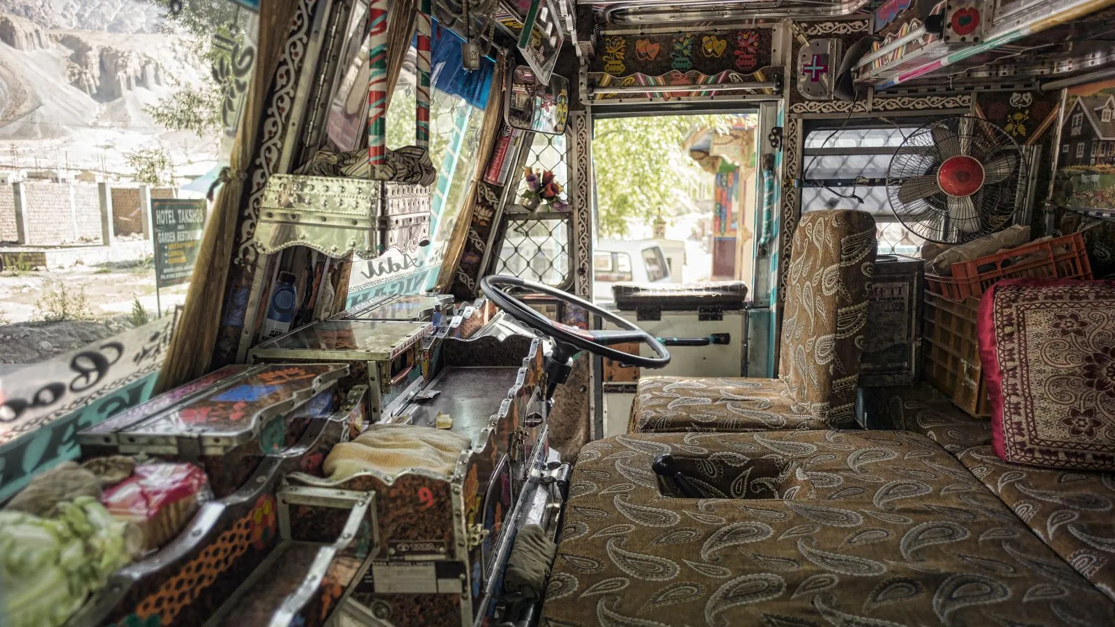 Decorated driver cabin of an Indian goods truck, the everyday workplace behind trip sheets and freight bills