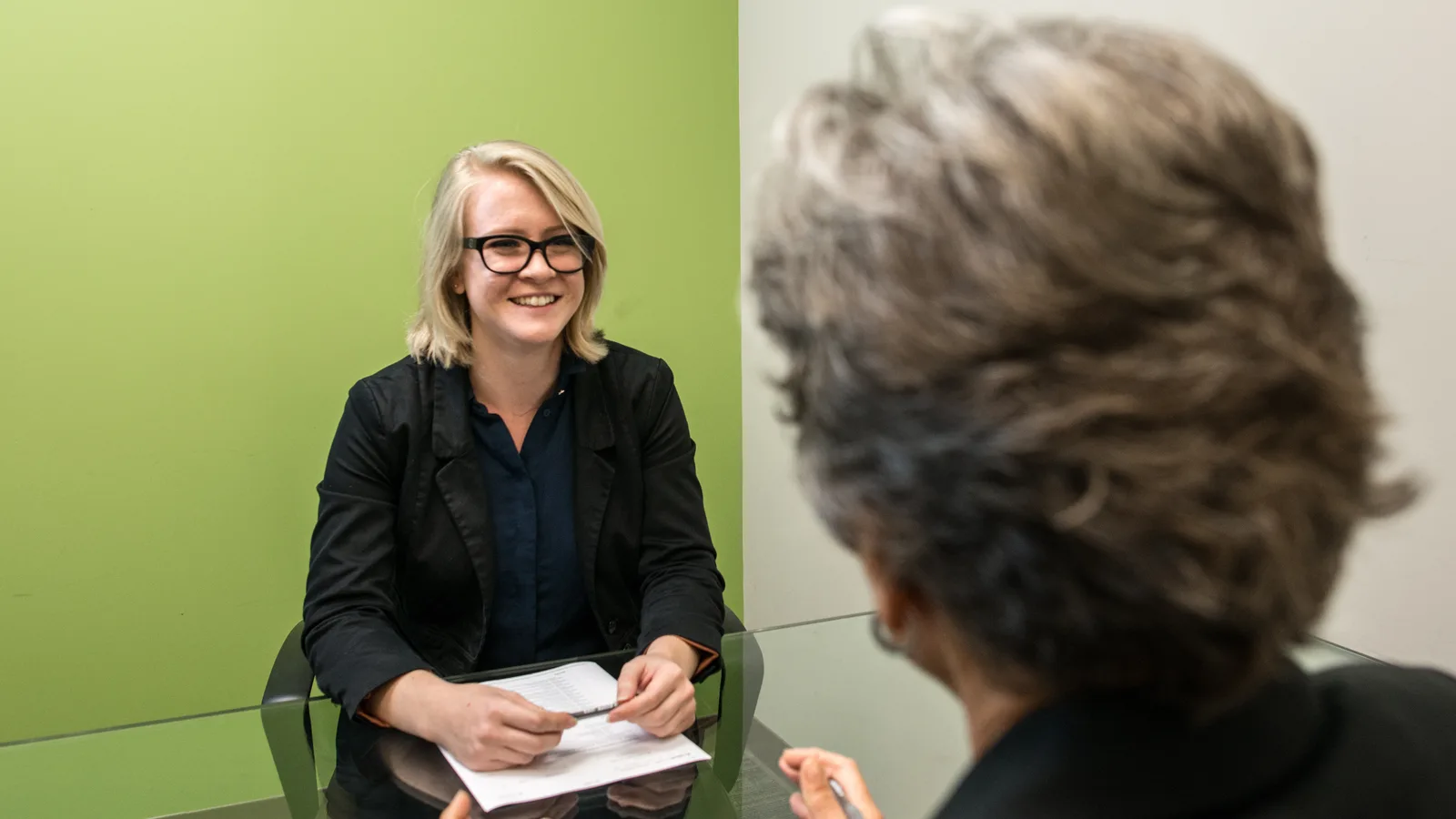Interviewer speaking with a job candidate across a table