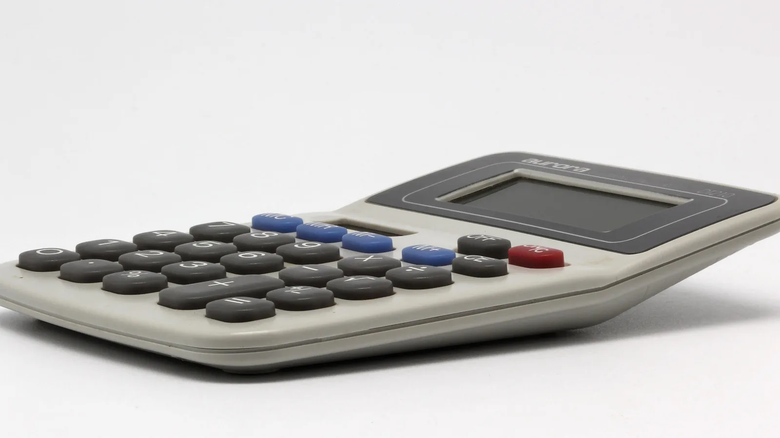 Desktop electronic calculator with memory keys on a plain white surface