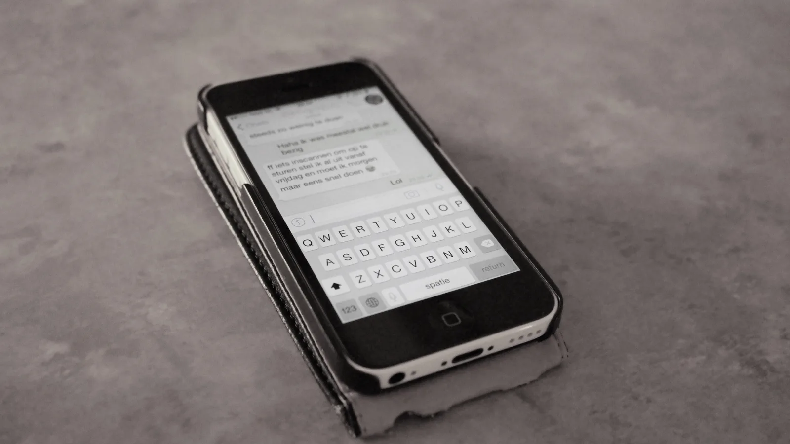 Smartphone showing a chat conversation with the on-screen keyboard open, the kind of messaging customers use for order updates