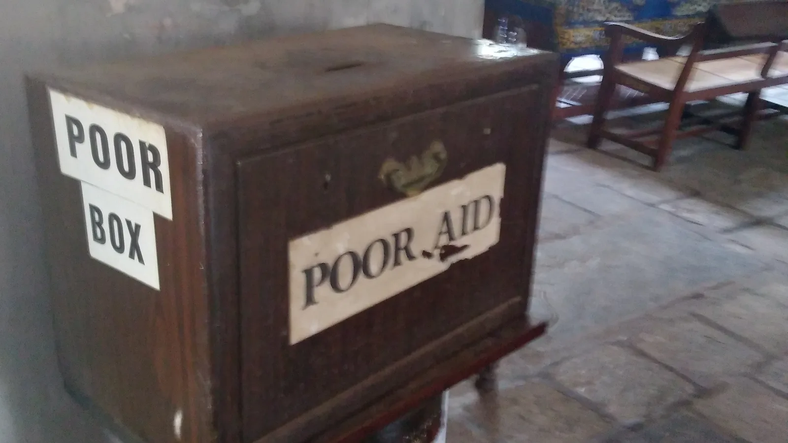 Wooden donation box labelled Poor Box and Poor Aid in India