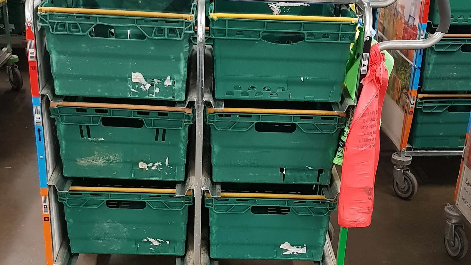 Online grocery picking trolley with stacked crates in a fulfilment area