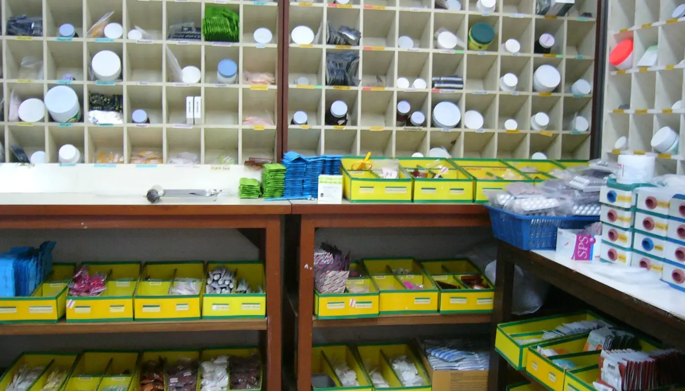Medicine cartons stacked on warehouse shelves at a pharma distributor in India